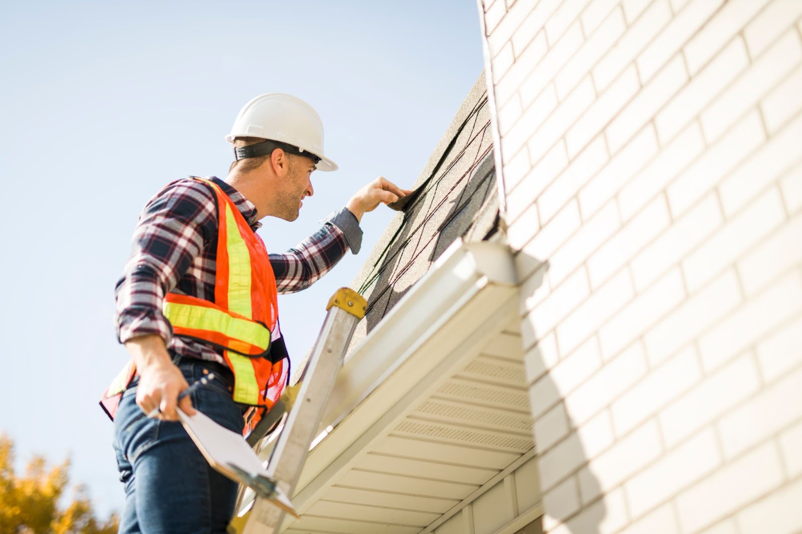 Roof expert checking for signs of damage on roof