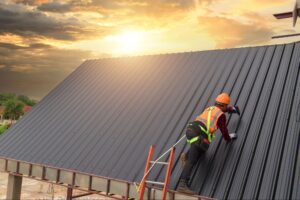 man-working-on-roof-at-sunset